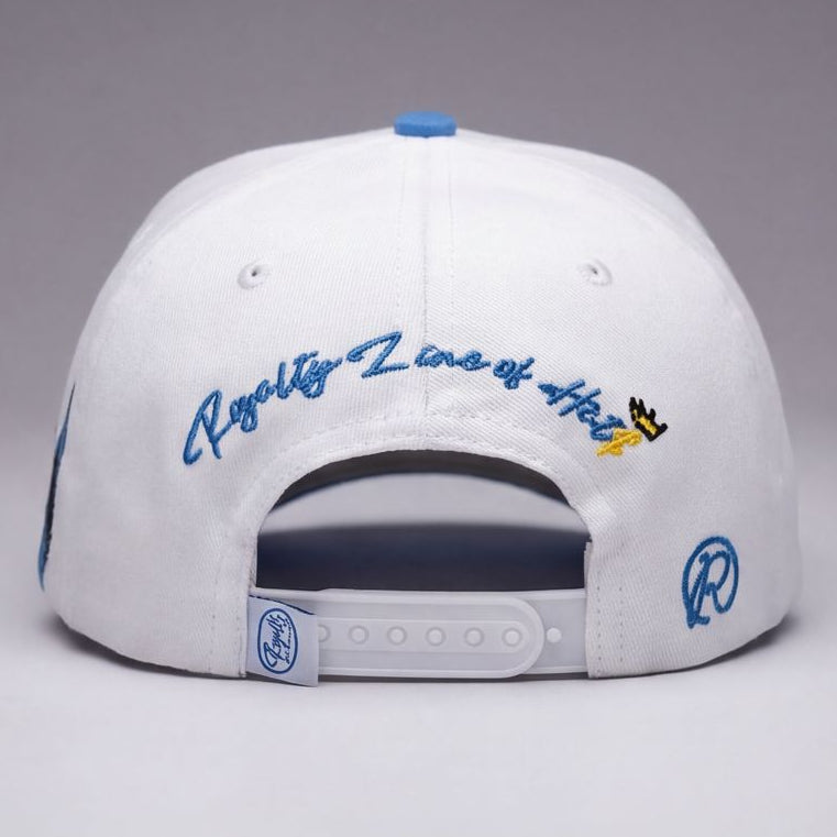 White and beige cap with blue and black designs on a gray background