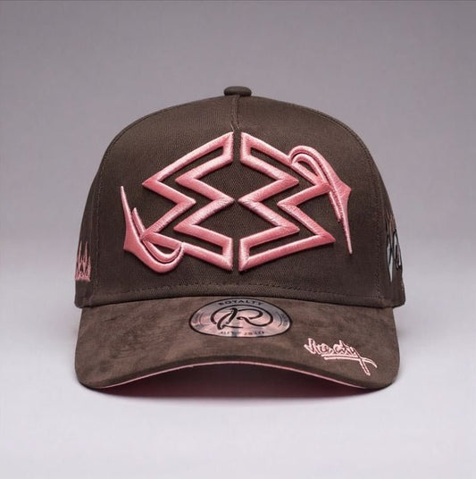 Brown cap with pink and white designs on a gray background