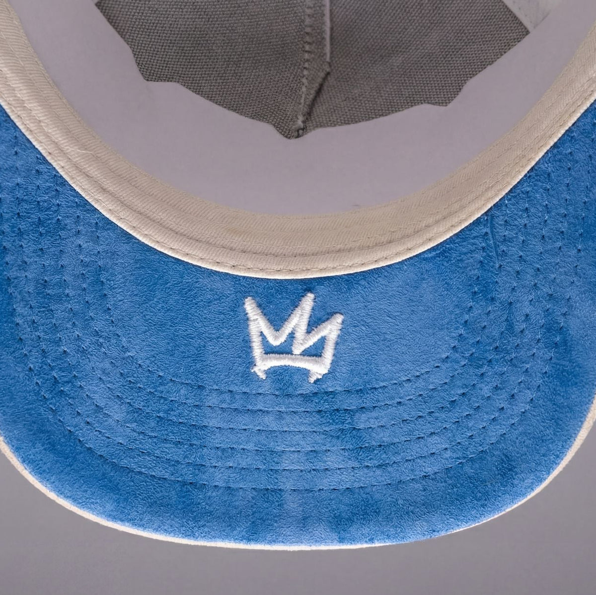 Blue visor with a white logo on a gray background