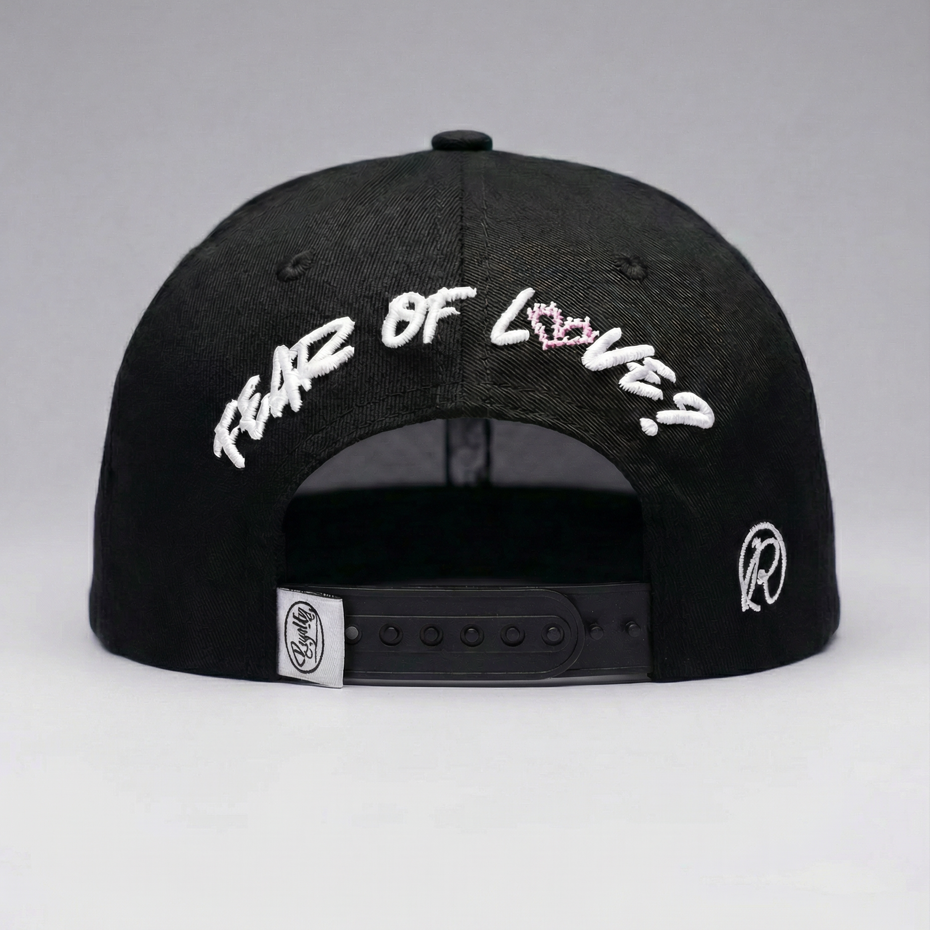 Black cap with white text on a gray background