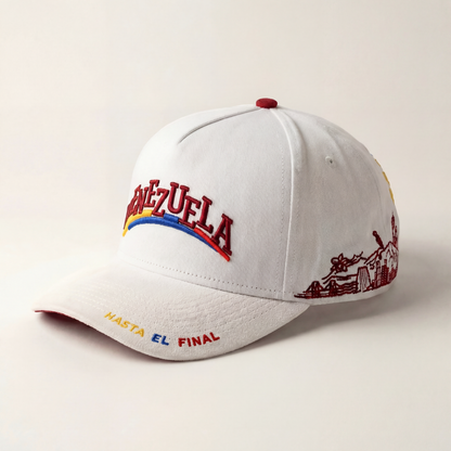 White cap with colorful text and graphics on a beige background