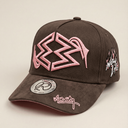 Brown cap with pink and white designs on a beige background