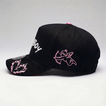Black cap with pink and white designs on a light gray background